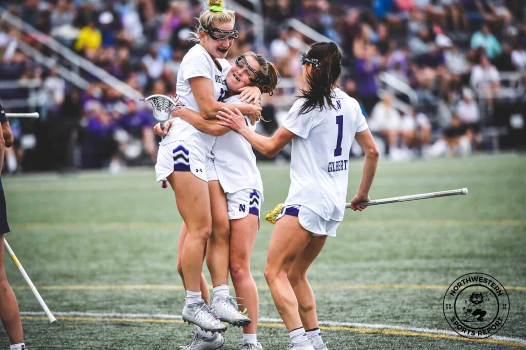 Northwestern lacrosse players hug each other after a game.