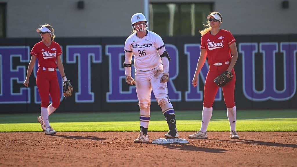 A Northwestern softball player stands on a base