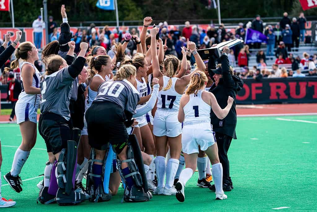 The Northwestern Field Hockey team holds up a trophy celebrating their Big Ten regular season championship.