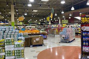 Colorful shelves with ingredients and white overhead lighting.