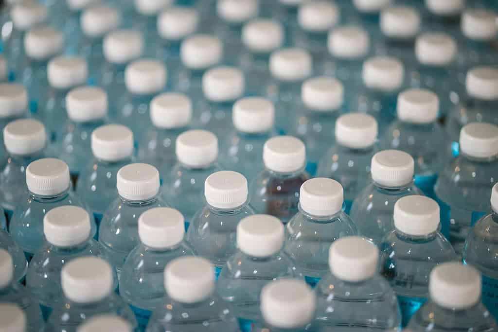 Angled photo of rows and rows of plastic water bottles lined up.